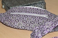 two purple fanny packs on a table