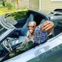 a man sitting in a sports car